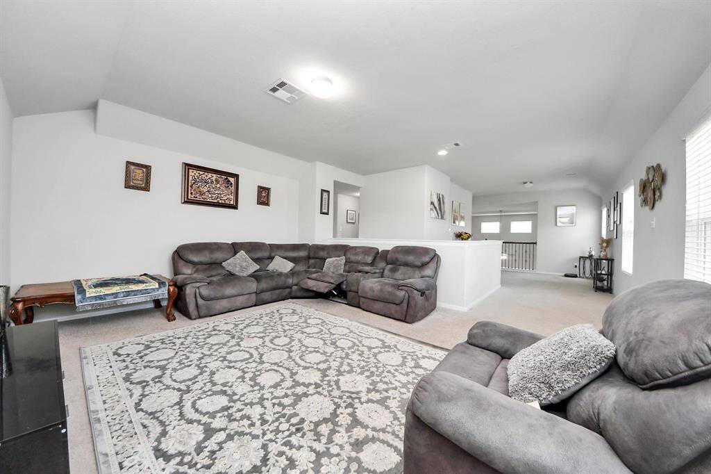 Hallway with built-in shelving and multiple access points to bedrooms and bath.