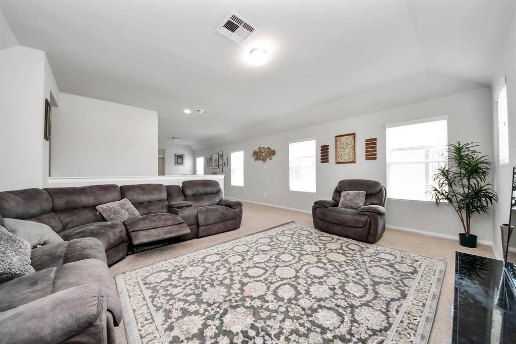Secondary bedroom with bright window and spacious layout.