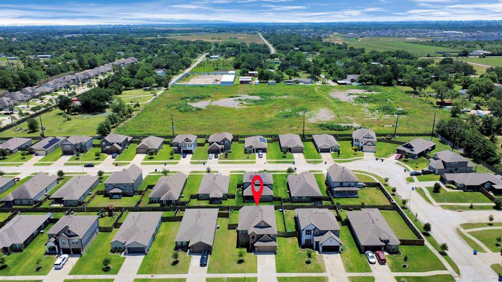 Large fully fenced backyard with extended patio and lush lawn.