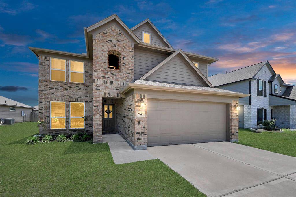 Large fully fenced backyard with extended patio and lush lawn.