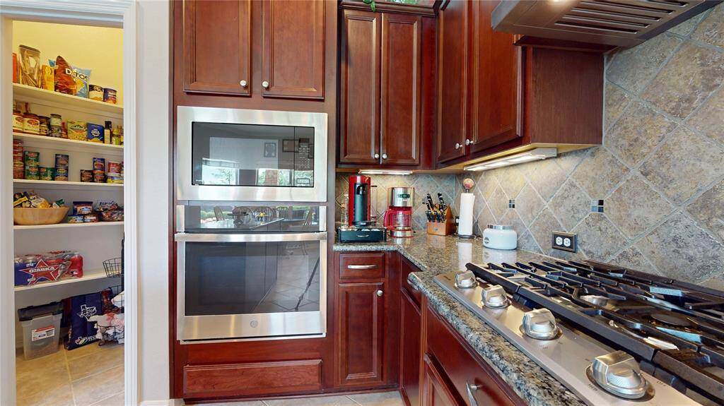 Recently updated appliances—including the cooktop, built-in microwave, oven, and dishwasher—add modern convenience to the timeless design