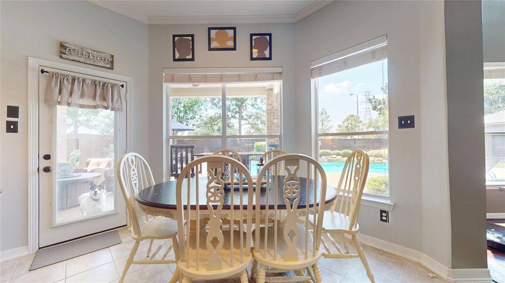 Enjoy abundant natural light from the large windows overlooking the backyard and pool, with easy access to the covered patio through the adjacent breakfast nook.