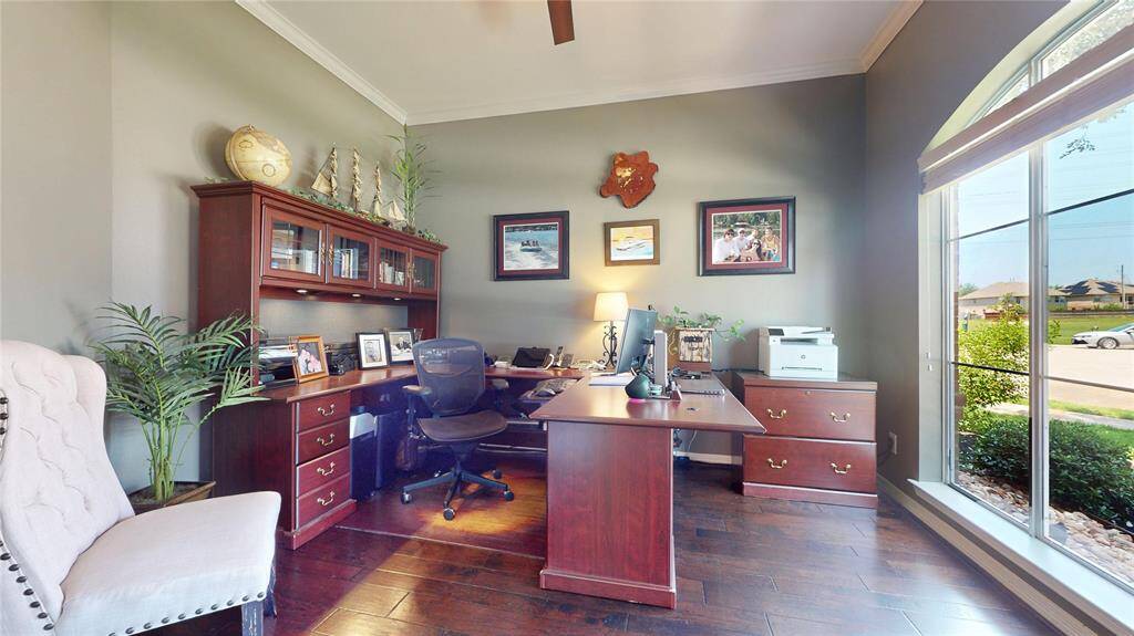 Work from home in comfort and style in this dedicated office space located at the front of the home. Overlooking a quiet cul-de-sac, the large arched window fills the room with natural light and provides a peaceful view of the tree-lined street. French doors offer both elegance and privacy, while rich hardwood flooring and crown molding add a refined touch.