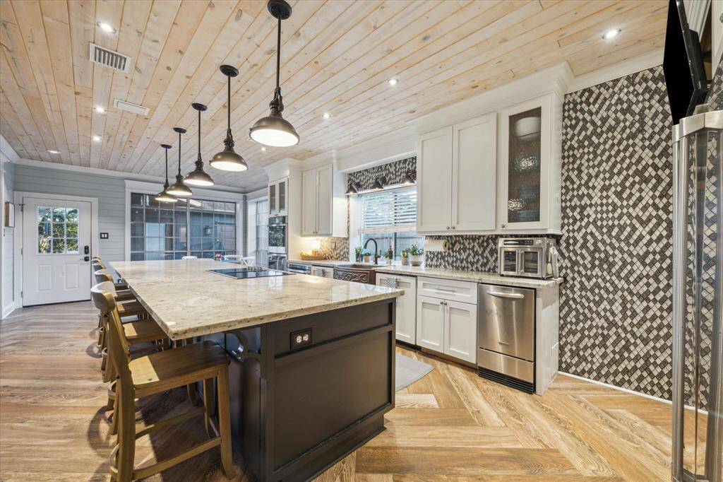 Enjoy a well-appointed kitchen with an ice maker, ample storage, and solar screens on the windows for added comfort and energy efficiency.