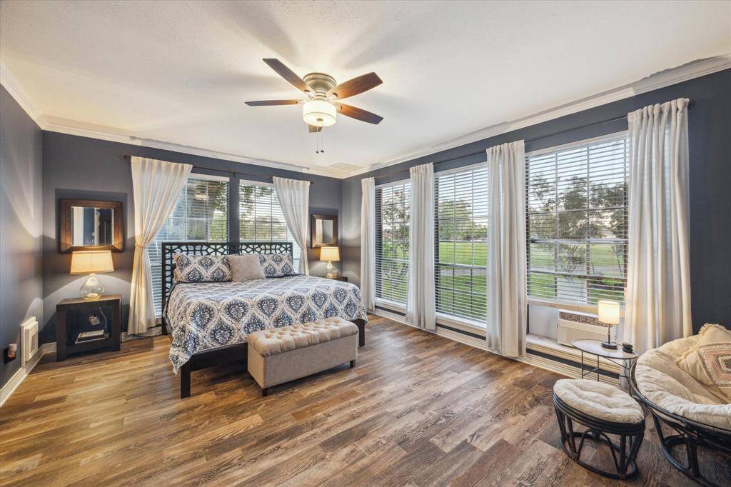 This light-filled primary bedroom offers generous space, a large closet, and room for a sitting area-creating a calm, comfortable retreat.