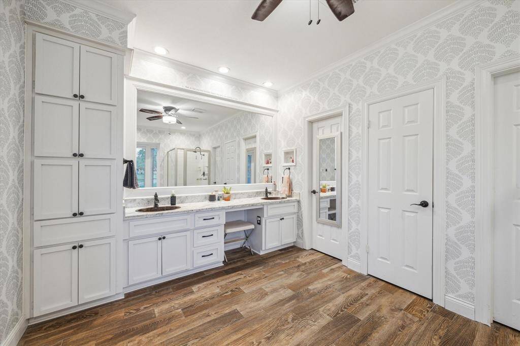 Enjoy your own dedicated vanity area with ample storage, and large walk in closets.