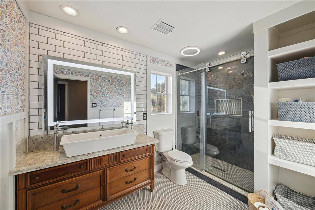 Beautiful secondary bathroom with plenty of space, walk-in shower and natural light