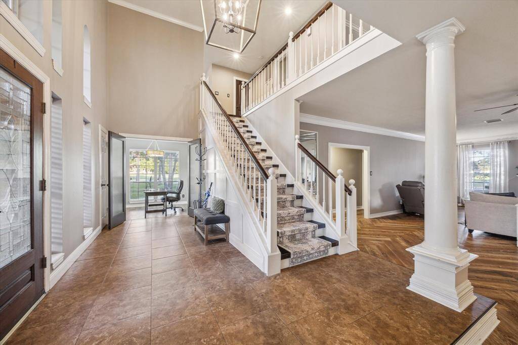 View of the beautiful staircase with newly updated carpet tread and your home office.