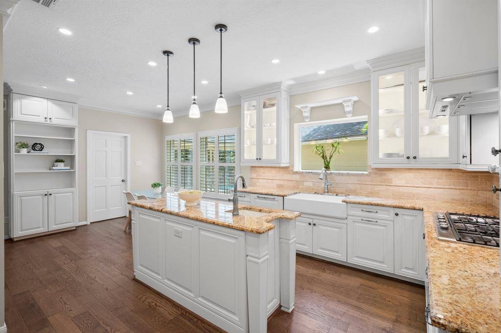 The kitchen is loaded with updates: custom soft close cabinets, double pane windows, and farmhouse sink.