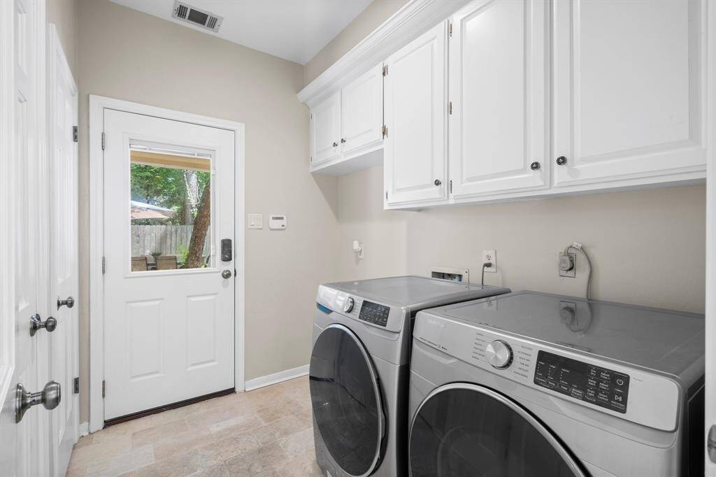 Utility room off of the kitchen leading out to the backyard
