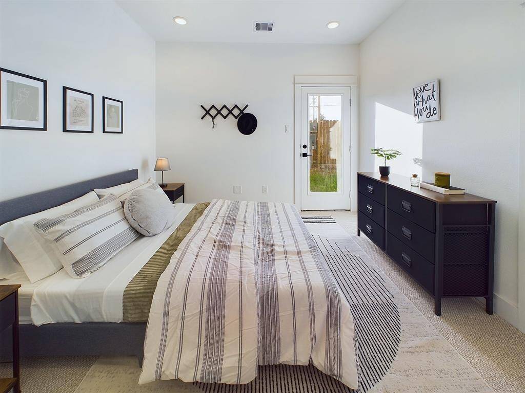Secondary bedroom on the first floor with access to the backyard. FINISHES & FLOOR PLANS WILL VARY! Ceiling fans are not included!