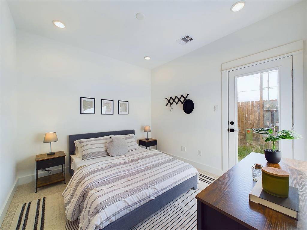 Secondary bedroom on the first floor with access to the backyard. FINISHES & FLOOR PLANS WILL VARY! Ceiling fans are not included!