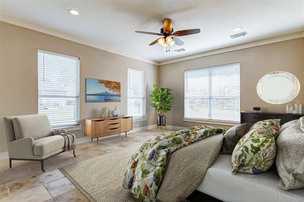 Retreat to this tranquil primarysuite, featuring a spaciouslayout, large windows, andbeautiful flooring. The highceilings and ceiling fan create acomfortable and airy ambiance.  *Virtually Staged