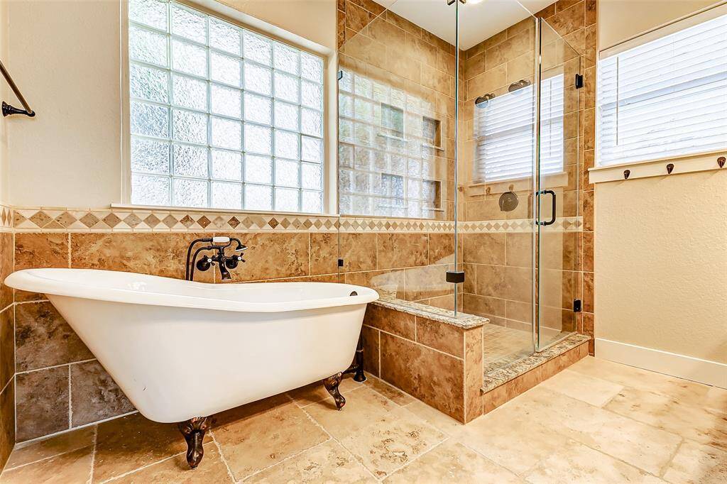 Other features include aspacious walk-in shower withmultiple showerheads and adeep soaking tub, ideal forunwinding after a long day.