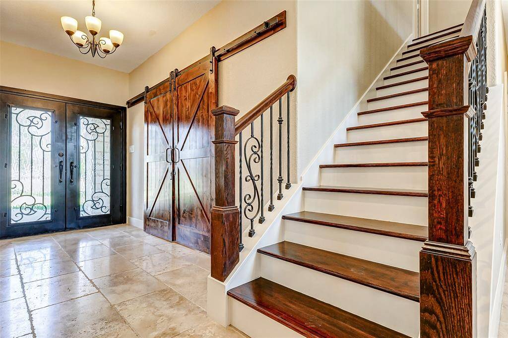 Follow the wooden staircase withwhite risers and iron spindles to the second level of the home where you'll find a massive game room, and the secondary bedrooms.
