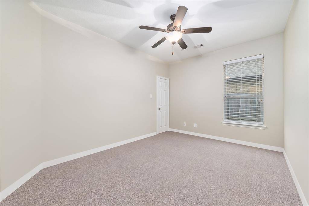 Secondary bedroom #2 at the front of the home. Has been virtually altered to remove boxes.