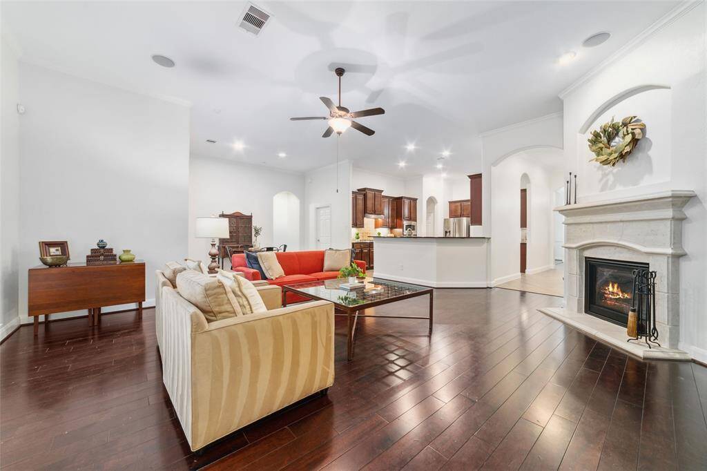 Another view of the living room with gas fireplace and open to breakfast and kitchen area.
