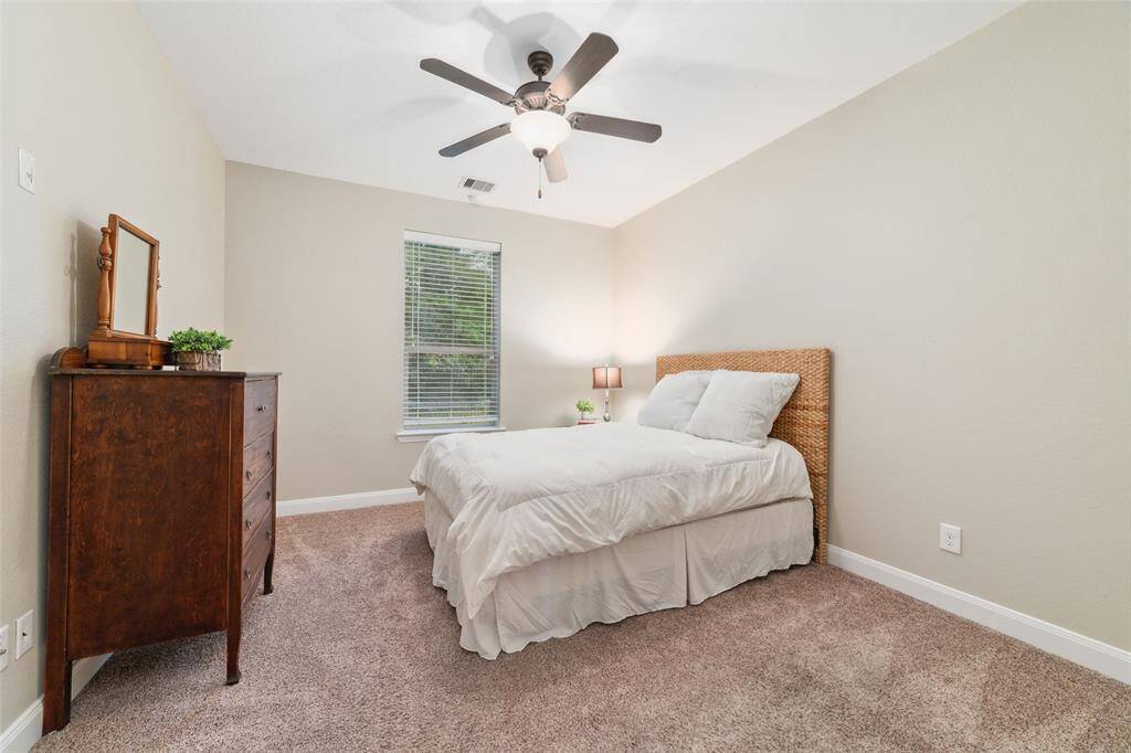 Just past the laundry room is a hallway leading to the third secondary bedroom and full bathroom at the back of the home.