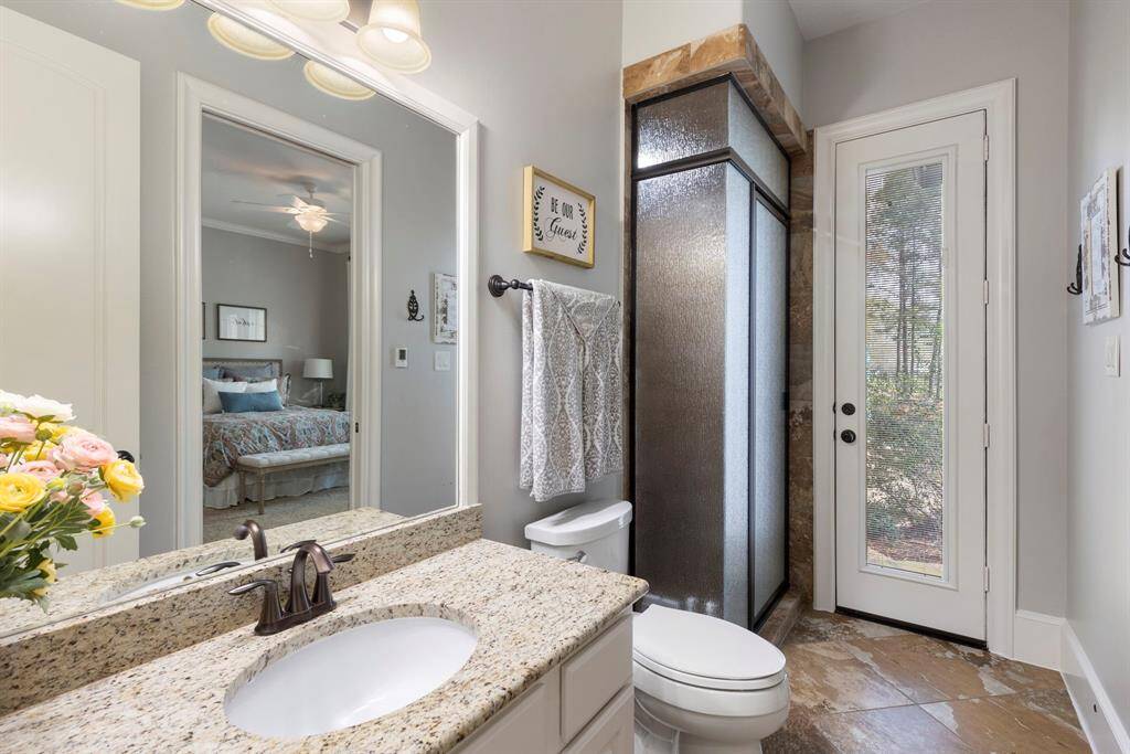 En-suite bathroom for the downstairs guest bedroom.  Exterior access to use as a pool bath too.