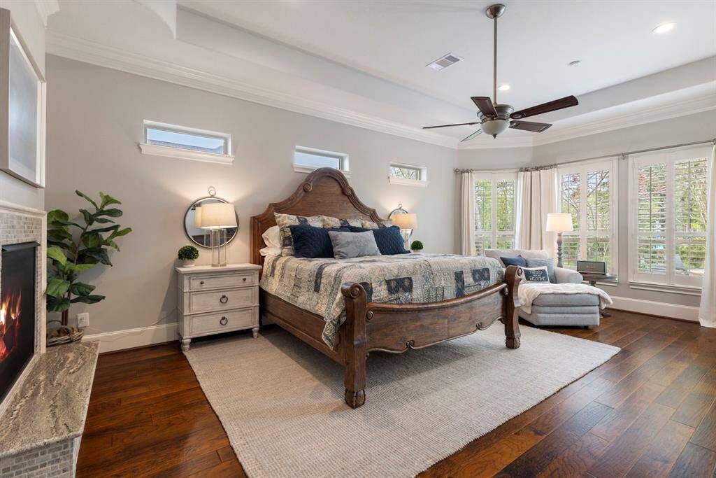 Extraordinary primary suite with tray ceiling and a 2 sided fireplace.