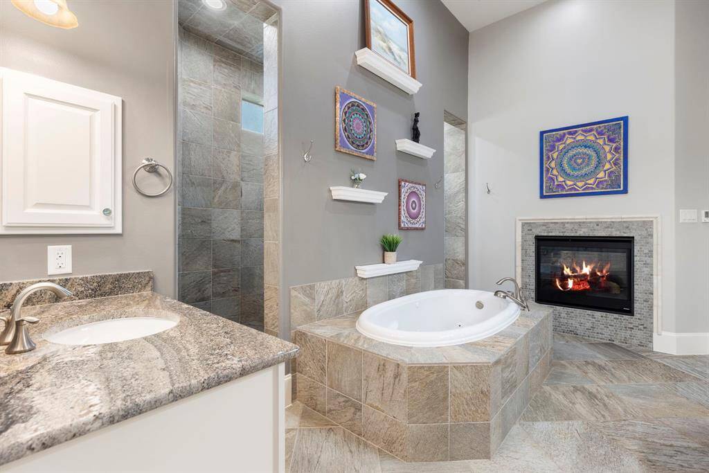 Beautiful primary bath, enjoy a bath next to the fireplace.