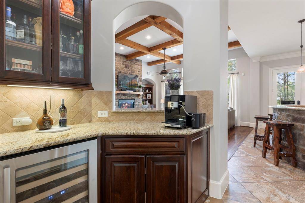 Dry bar between dining and kitchen with a built-in wine refrigerator.