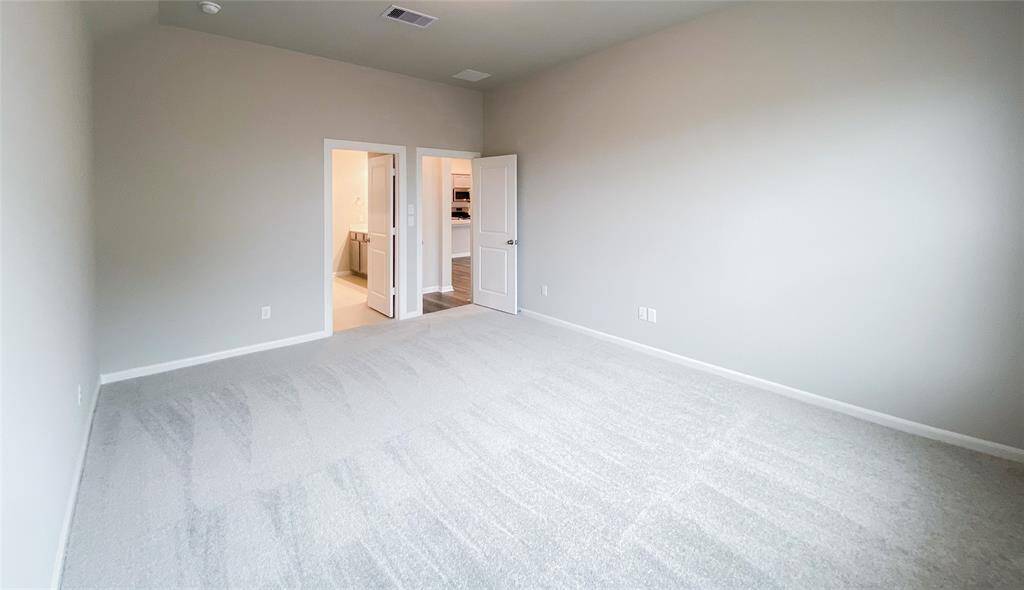 Light and bright master bedroom with soft carpet flooring