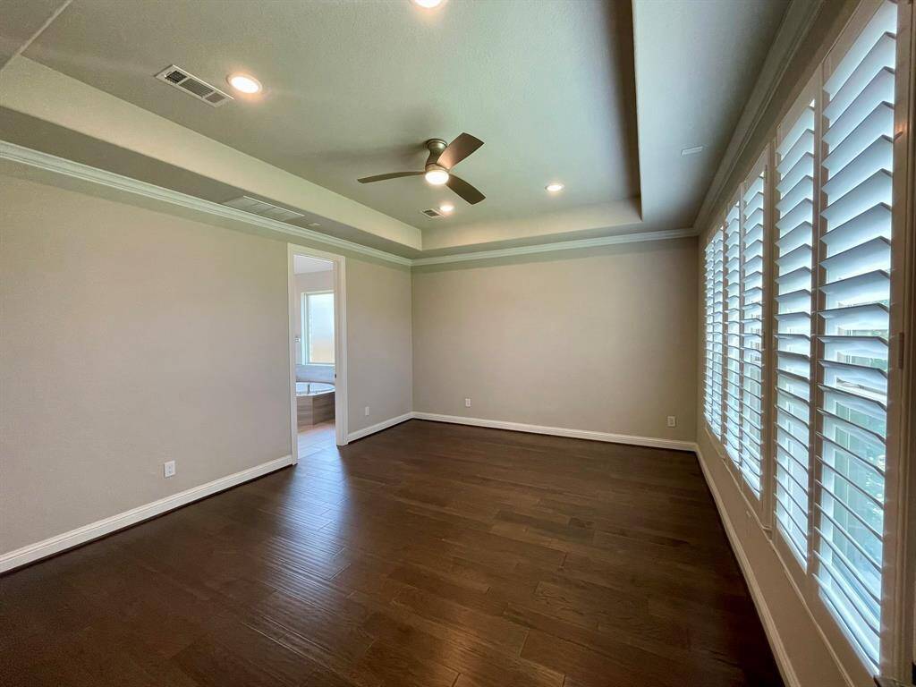 Wood Floors and Plantation Shutters continue in here.  Tray Ceiling is a nice architectural detail.