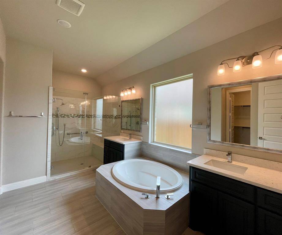All you could want in a Primary Suite Bathroom.  Split sinks, soaking tub & oversized shower with bench.