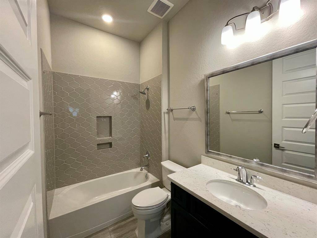 Overized Vanity in this tidy Bathroom.