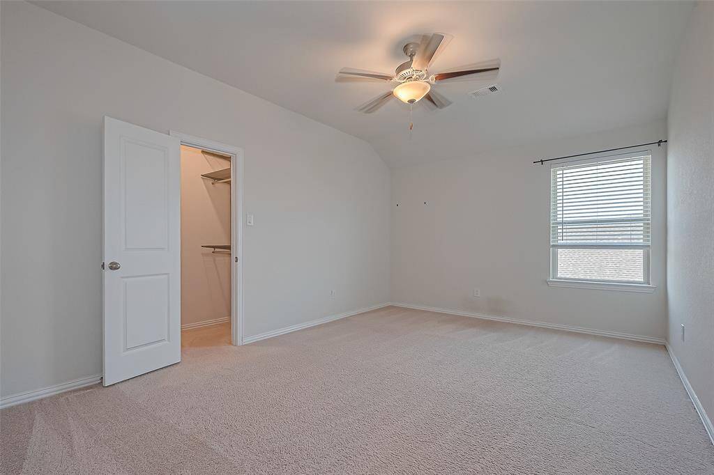 This bedroom offers a peaceful retreat with plenty of space for furnishings and personal touches