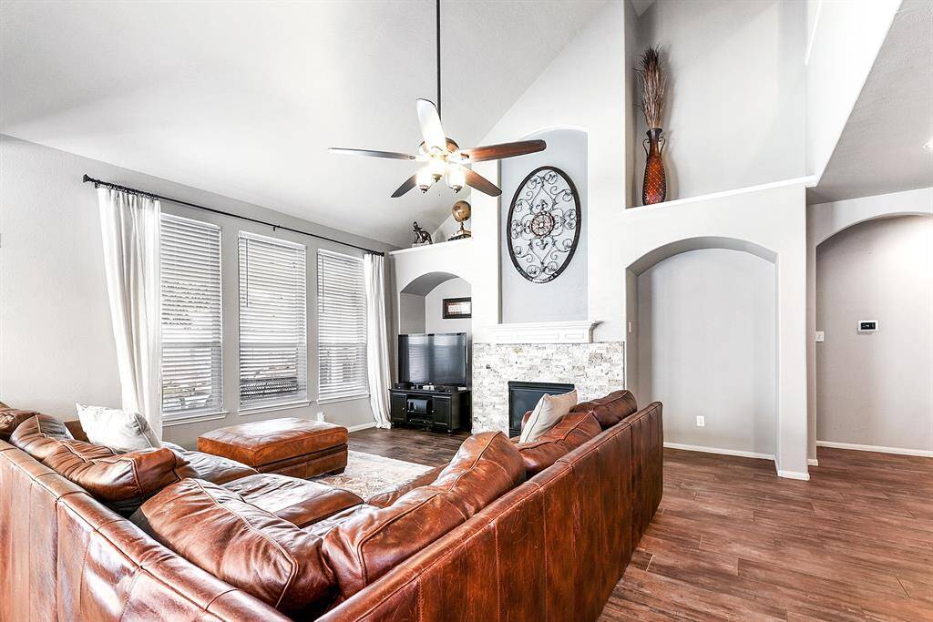 Three large windows in the living area face the backyard, offering stunning views of the pool and spa. These windows allow for abundant natural light, creating a bright and airy atmosphere while seamlessly connecting the indoor space with the backyard oasis.