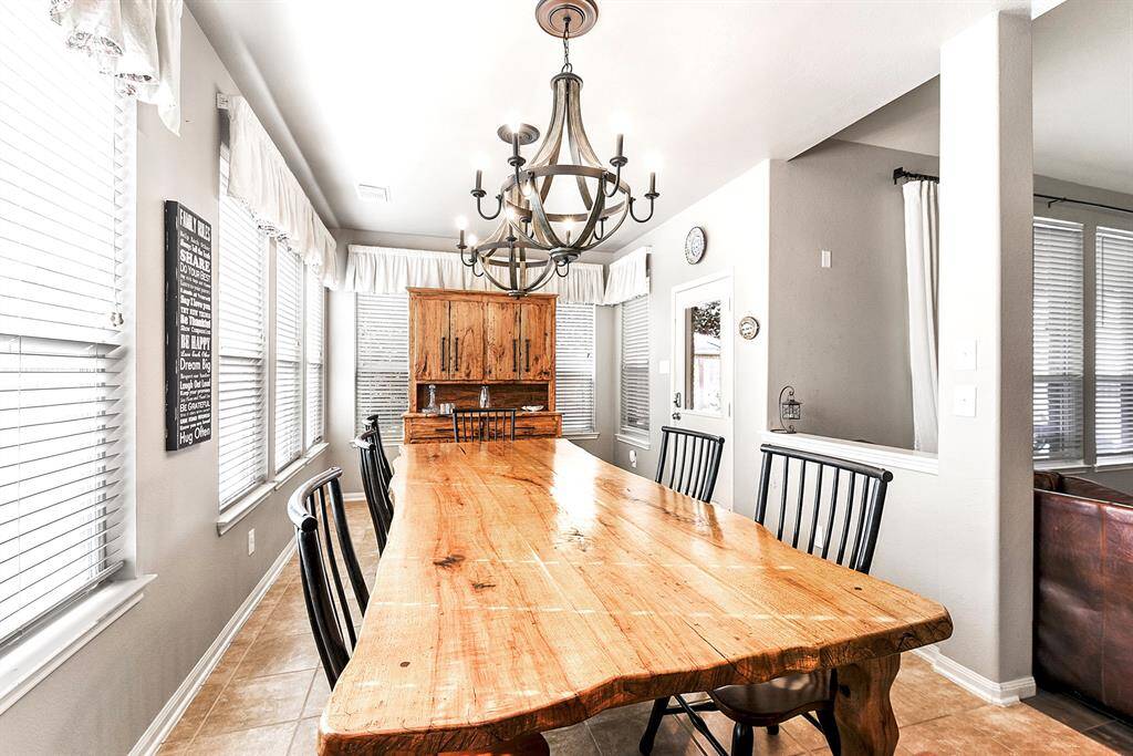 Another view of this oversized breakfast room highlights its easy access to the backyard’s covered patio, making it perfect for indoor-outdoor dining and entertaining.