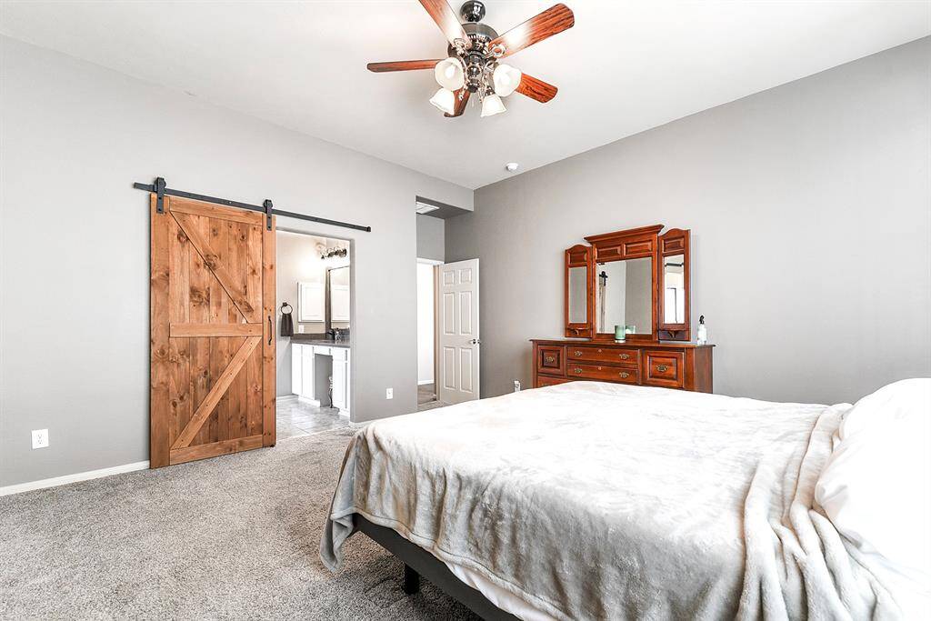 Nestled in the left corner of the main floor is the spacious primary en suite. This inviting retreat offers plenty of room for large furniture and even a separate seating area. Enjoy beautiful backyard views, including the pool and spa. (only 2 bedrooms offer carpet.)