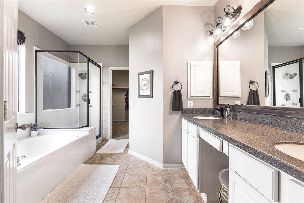The attached luxury primary en suite bathroom offers a separate shower and tub, double sinks, and a huge walk-in closet, providing both elegance and functionality. This spacious retreat is designed for ultimate comfort and convenience, creating the perfect space to unwind and refresh.