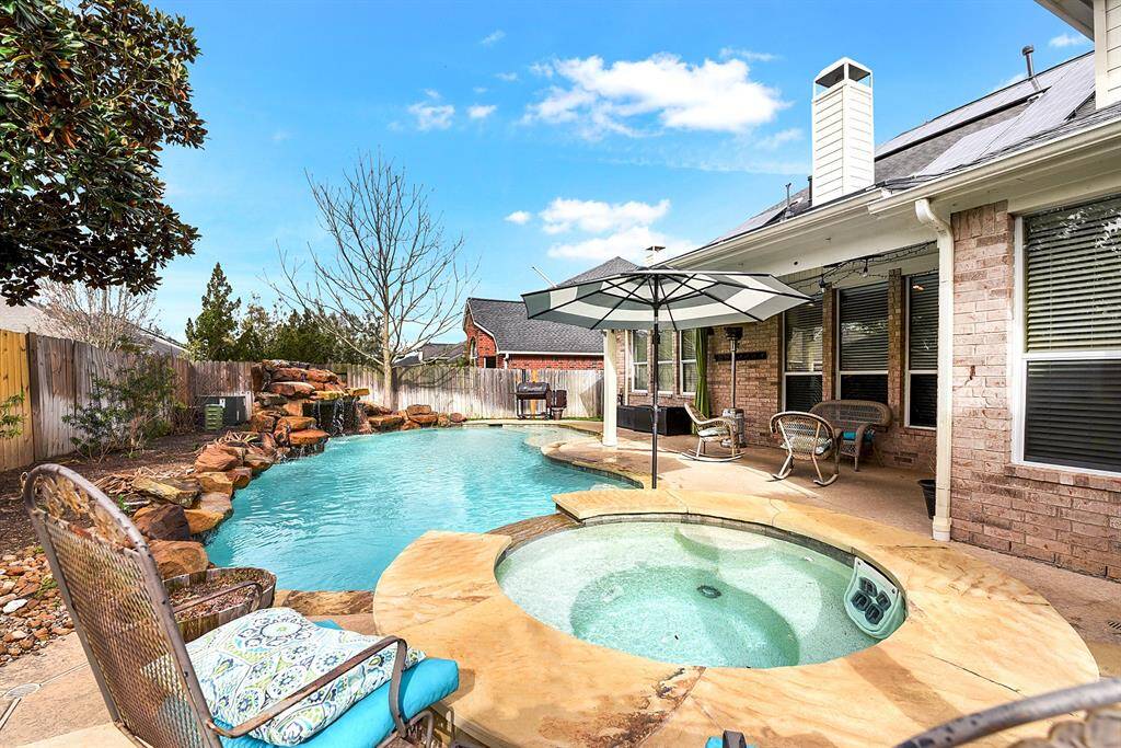 This amazing two-story home features a stunning pool and spa, complemented by a large back patio—perfect for barbecuing, entertaining, and outdoor dining. With an all-brick exterior and energy-efficient solar panels.