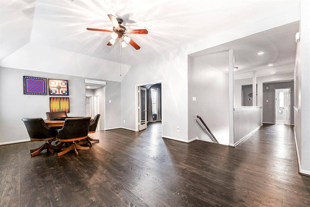 Another view of this spacious upstairs game room showcases French doors leading into a media room. Upstairs, you’ll find four guest bedrooms and two baths, featuring a split floor plan that separates the guest bedrooms for added privacy.