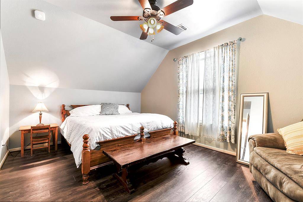 Another view showcases the spaciousness of this upstairs guest bedroom, highlighting its generous layout and ample room for furniture