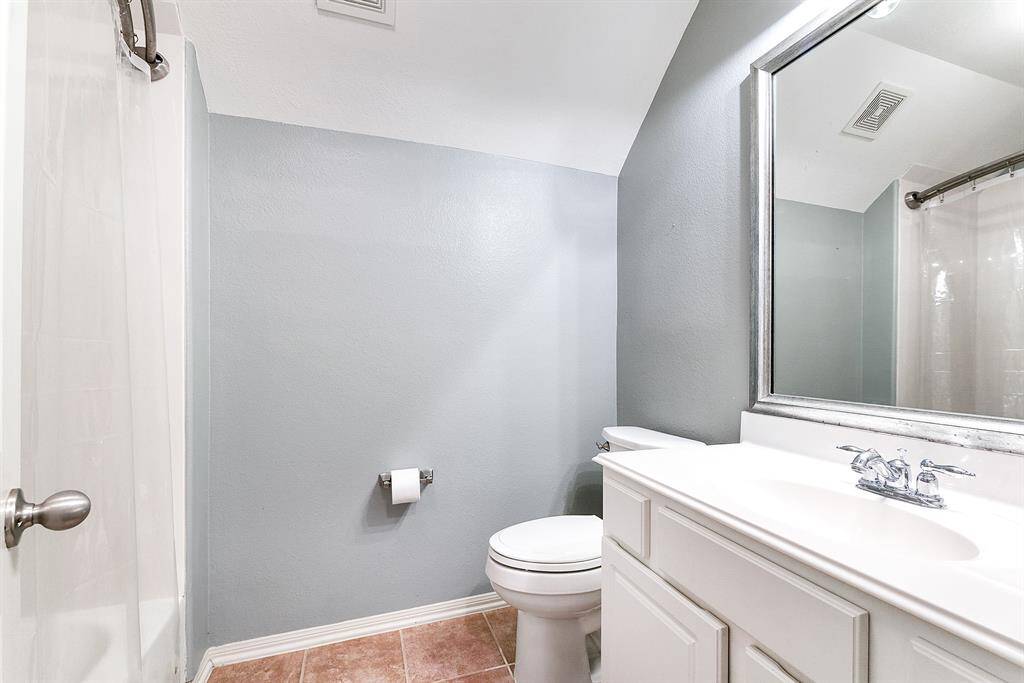 Upstairs offers two full bathrooms, both featuring a tub-shower combo and large vanities. These bathrooms provide ample storage and workspace, combining style and functionality for added convenience.