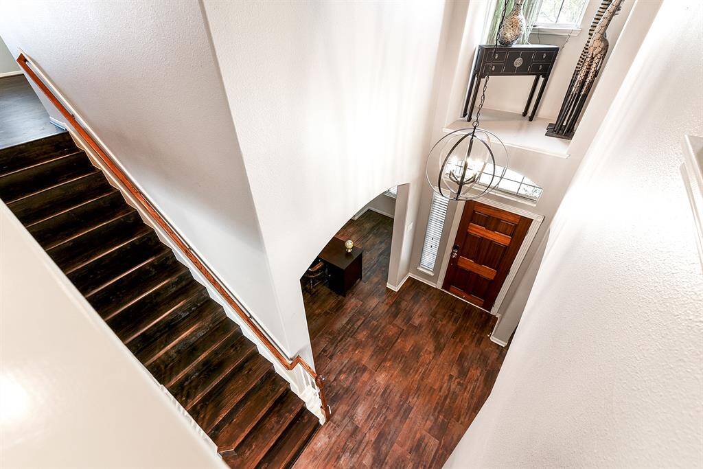 From upstairs, you can enjoy a view overlooking the large foyer and staircase. This design adds a sense of openness and elegance, creating a grand and welcoming entrance to the home.