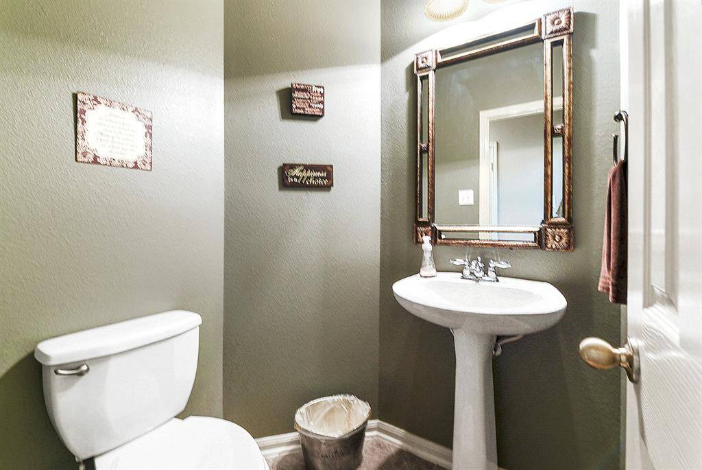 Downstairs offers this convenient guest powder room, providing easy access for visitors.