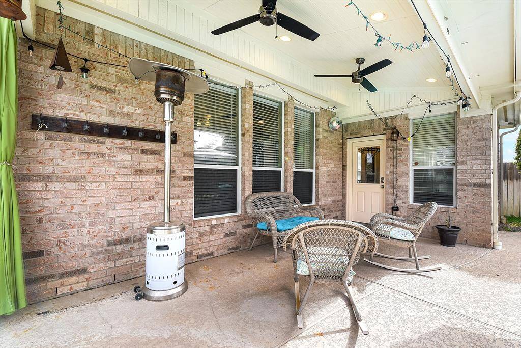 Another view highlights this versatile outdoor space, offering easy access to the home—perfect for effortless indoor-outdoor entertaining, barbecuing, and gatherings. Whether hosting guests or enjoying a quiet evening, this backyard is designed for both convenience and relaxation.