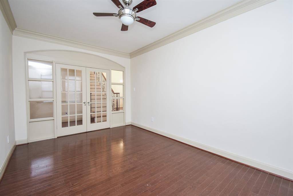 The office/flex room is the perfect retreat with hardwood flooring, french doors and ceiling fan.
