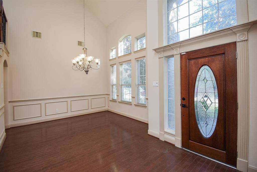 Spacious entryway with high ceilings and an abundance of natural light.