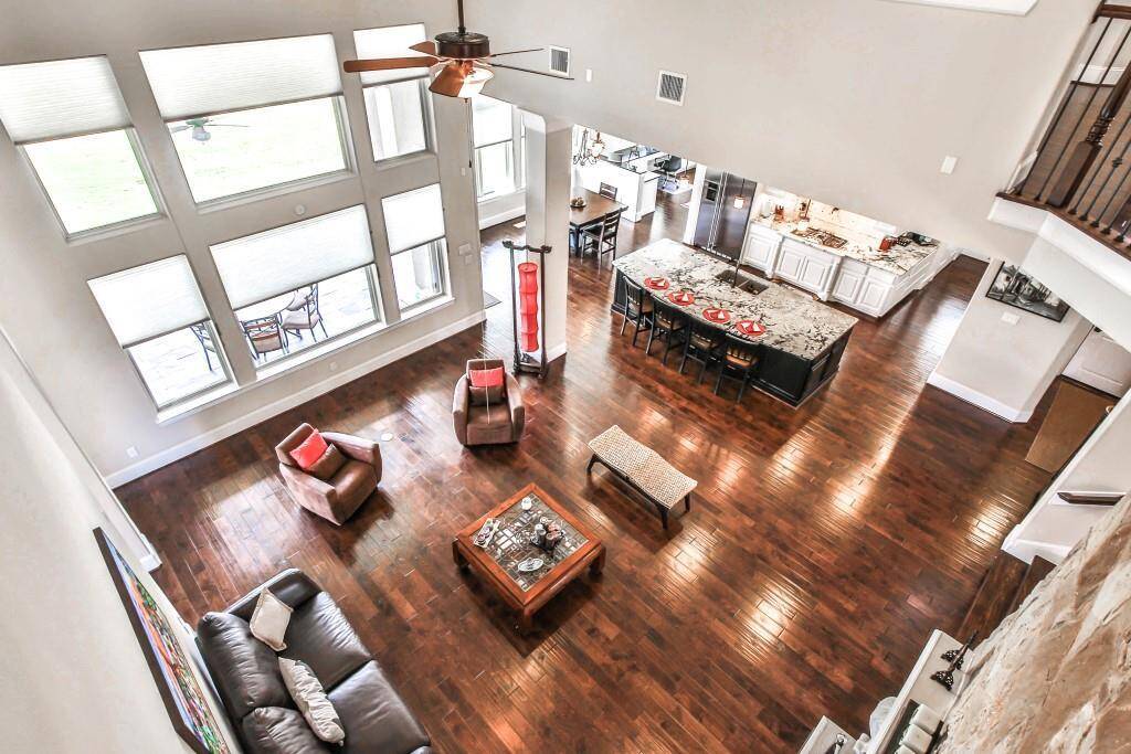 Showcasing soaring 2 story high ceilings with an exquisite grand wall of windows brings a wonderful WOW factor to this living space!