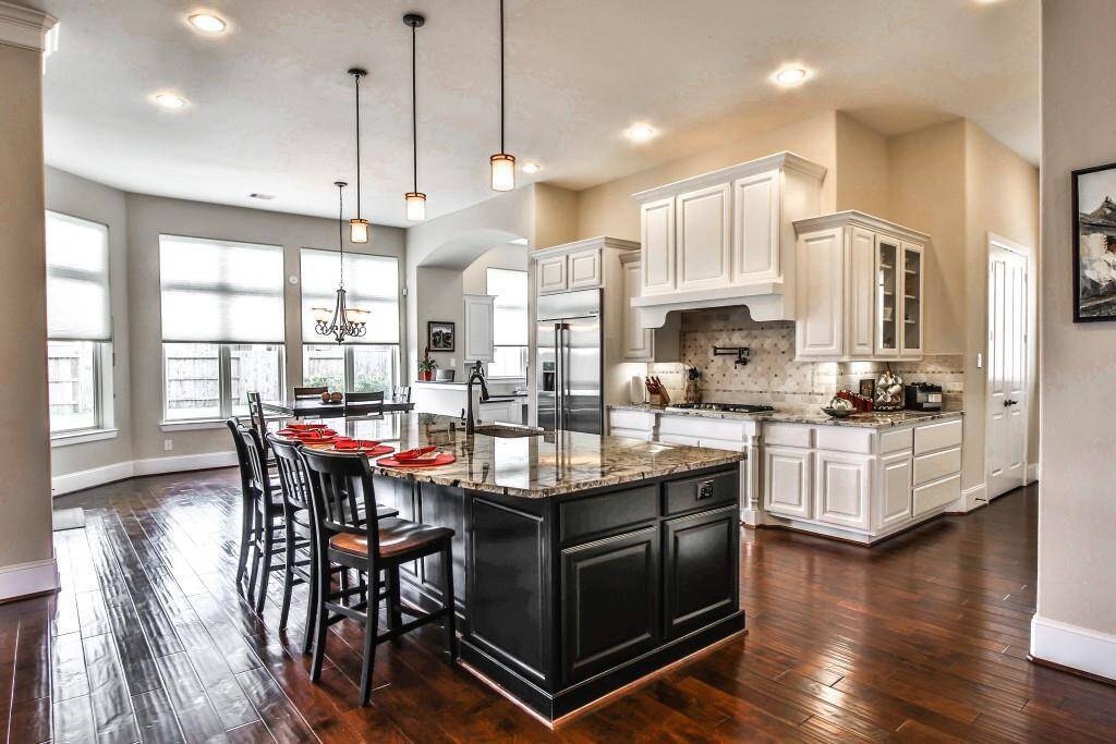 This Kitchen is by far any Chefs dream! Recessed lighting, stain steel appliances, white stained cabinetry, beautiful backsplash detailing, granite countertops, gas cook top and sleek modern fixtures!!!