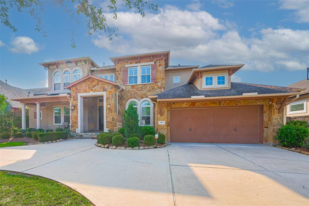 This is a spacious 2 story home with stone and stucco exterior.