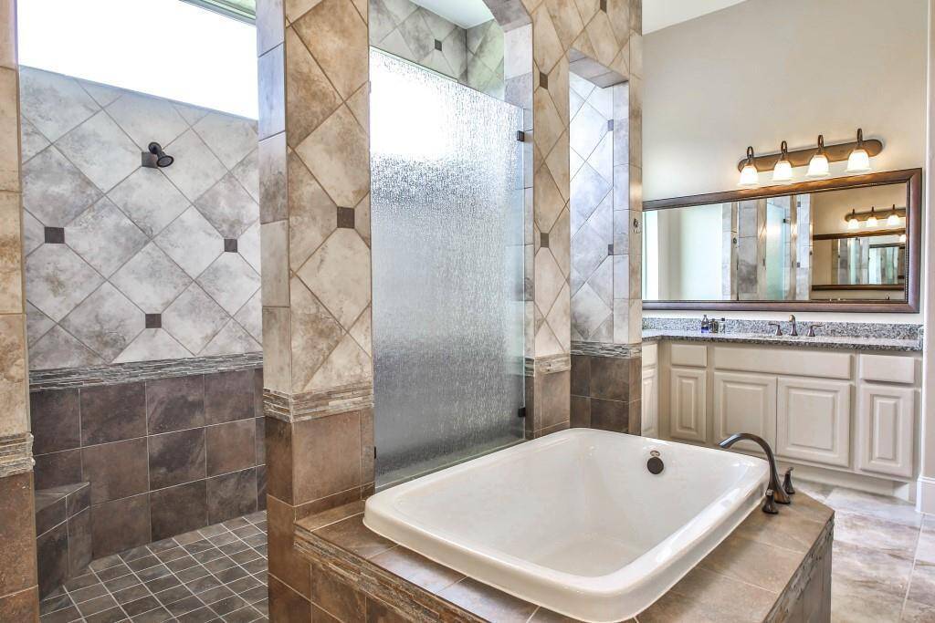 Master bath with relaxing tub, his and hers vanities and amazingly large walk in closet!