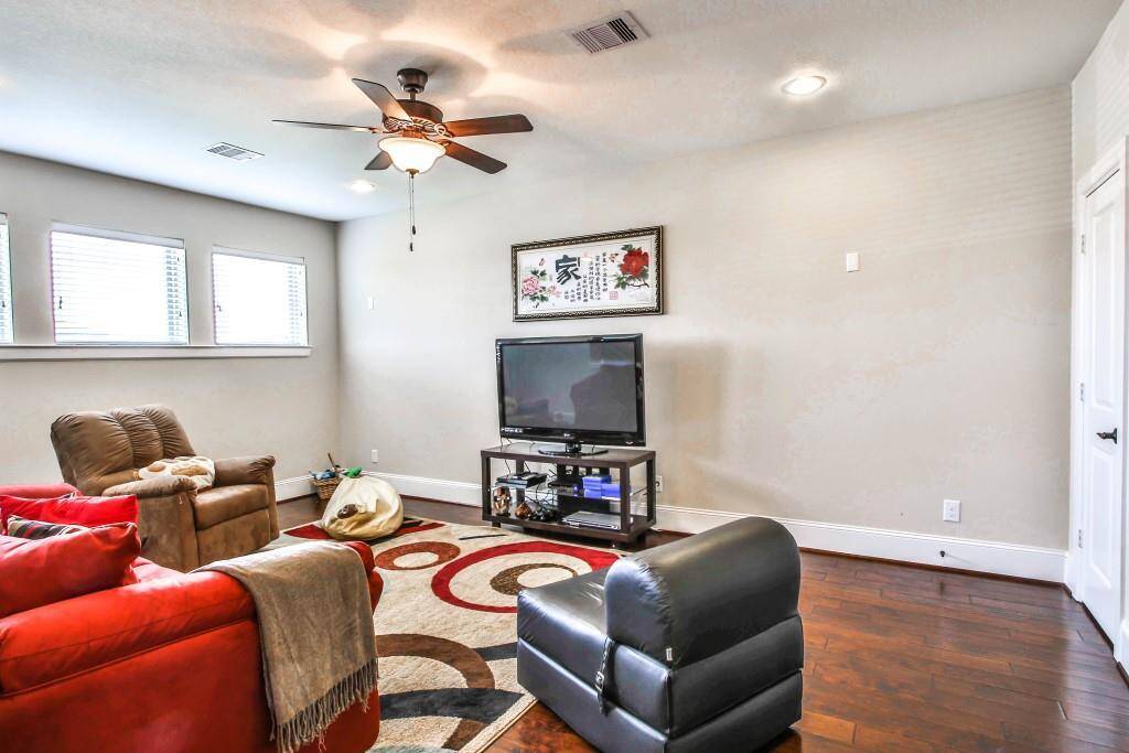 TV room has a built-in refrigerator and granite countertops.