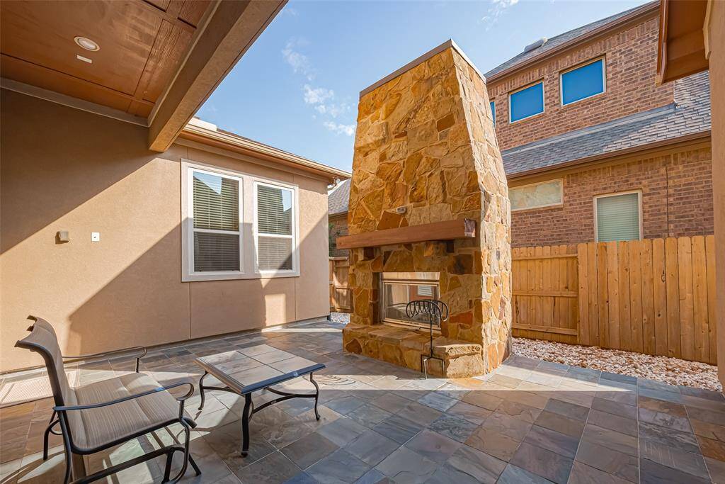 Outdoor patio with a fireplace.